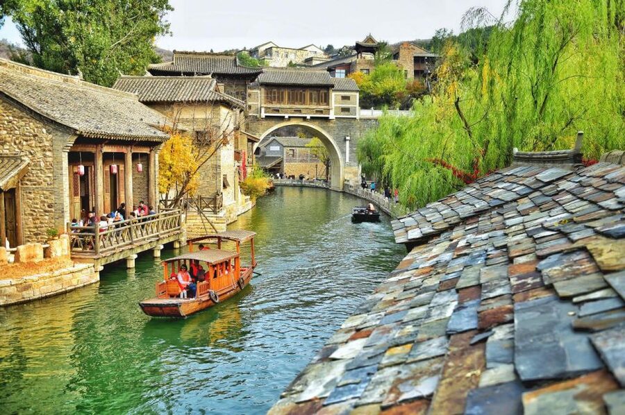Beijing: Jinshanling and Simatai Wall&Gubei Watertown Tour - Gubei Water Town at dusk: canals, shops, and lantern-lit views